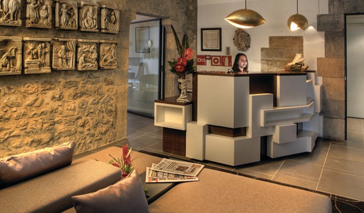 Hotel Llegendes de Girona Eastern Spain lobby desk sofas stone walls modern décor