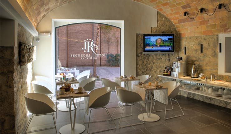 Breakfast buffet in a cafe with tables set out and breakfast spread 