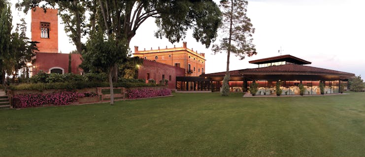 Hotel Mas la Boella Eastern Spain grounds lawn trees hotel in background