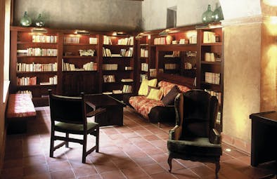 Hotel Mas la Boella Eastern Spain library indoor seating area bookshelves traditional décor