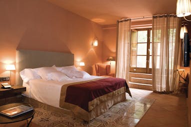 Hotel Mas la Boella Eastern Spain suite bedroom bed large windows cosy décor