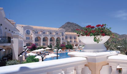 La Manga Club Resort Eastern Spain exterior pool white hotel outdoor pool umbrellas loungers and flowers