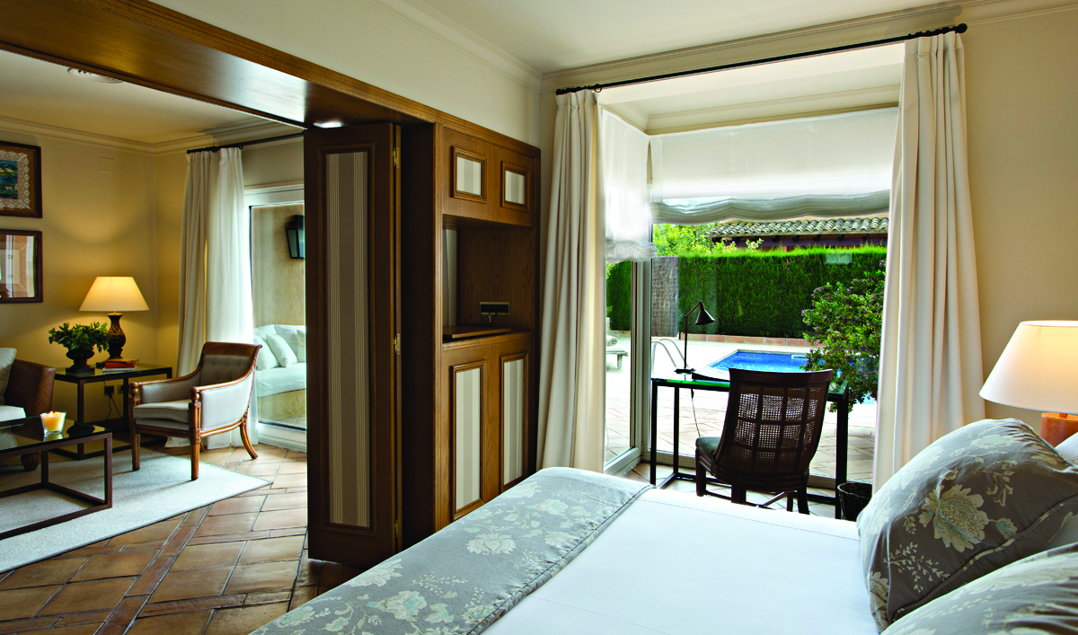 Mas de Torrent Catalonia pool suite bedroom lounge modern décor doors leading to private pool