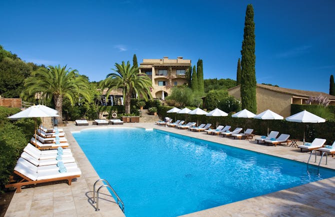 Mas de Torrent Catalonia pool sun loungers umbrellas palm trees