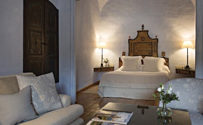 Mas de Torrent Catalonia suite masia wooden bed frame sofas traditional décor