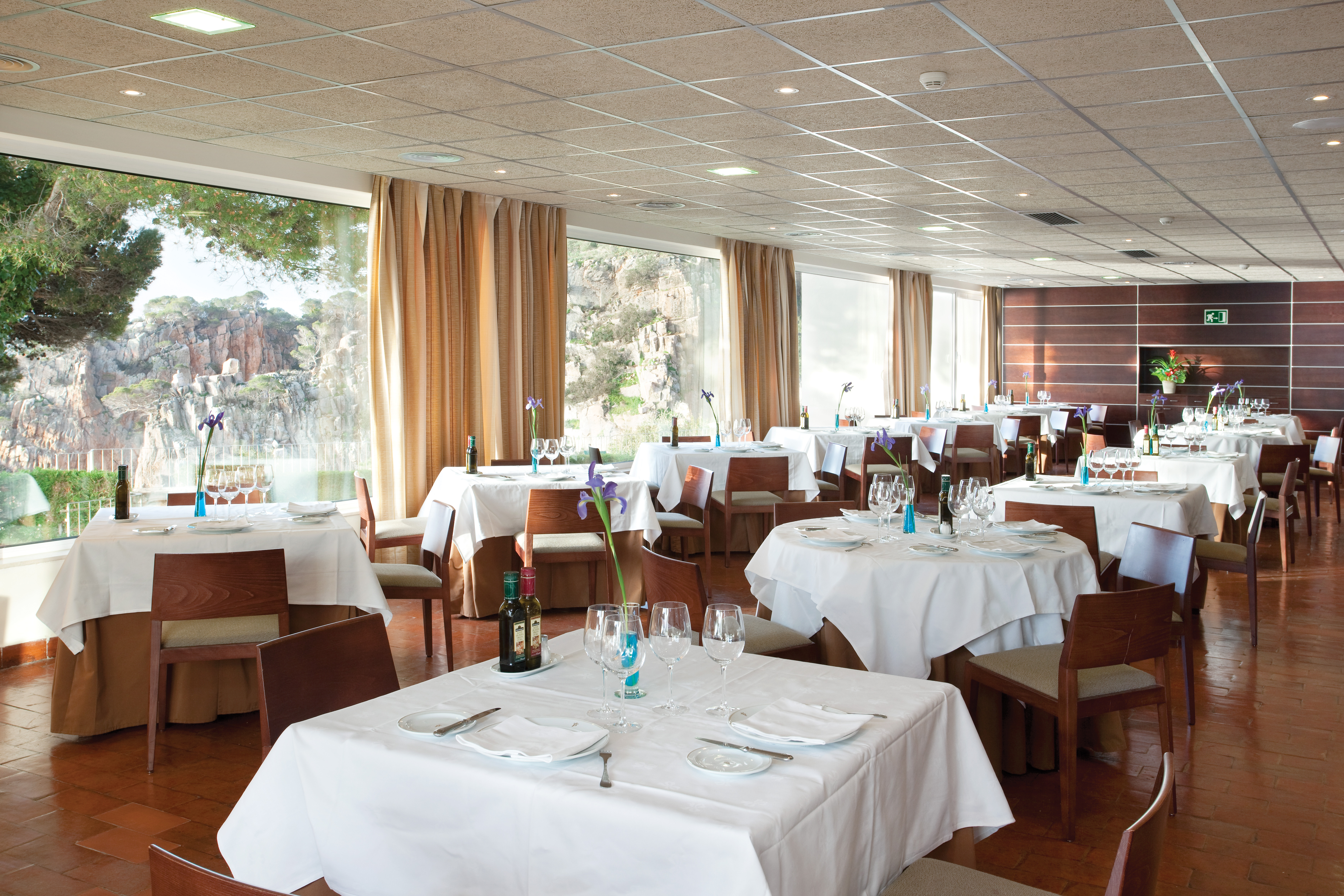 Restaurant with tables and chairs set up and laid out for dining