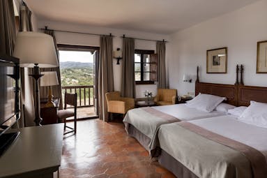 parador de tortosa spacious bedroom with two beds and a balcony