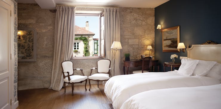 A Quinta Da Auga Galicia double room bed armchairs window elegant décor