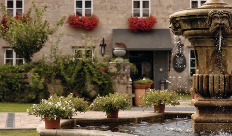 A Quinta Da Auga Galicia exterior stone building water feature plant pots