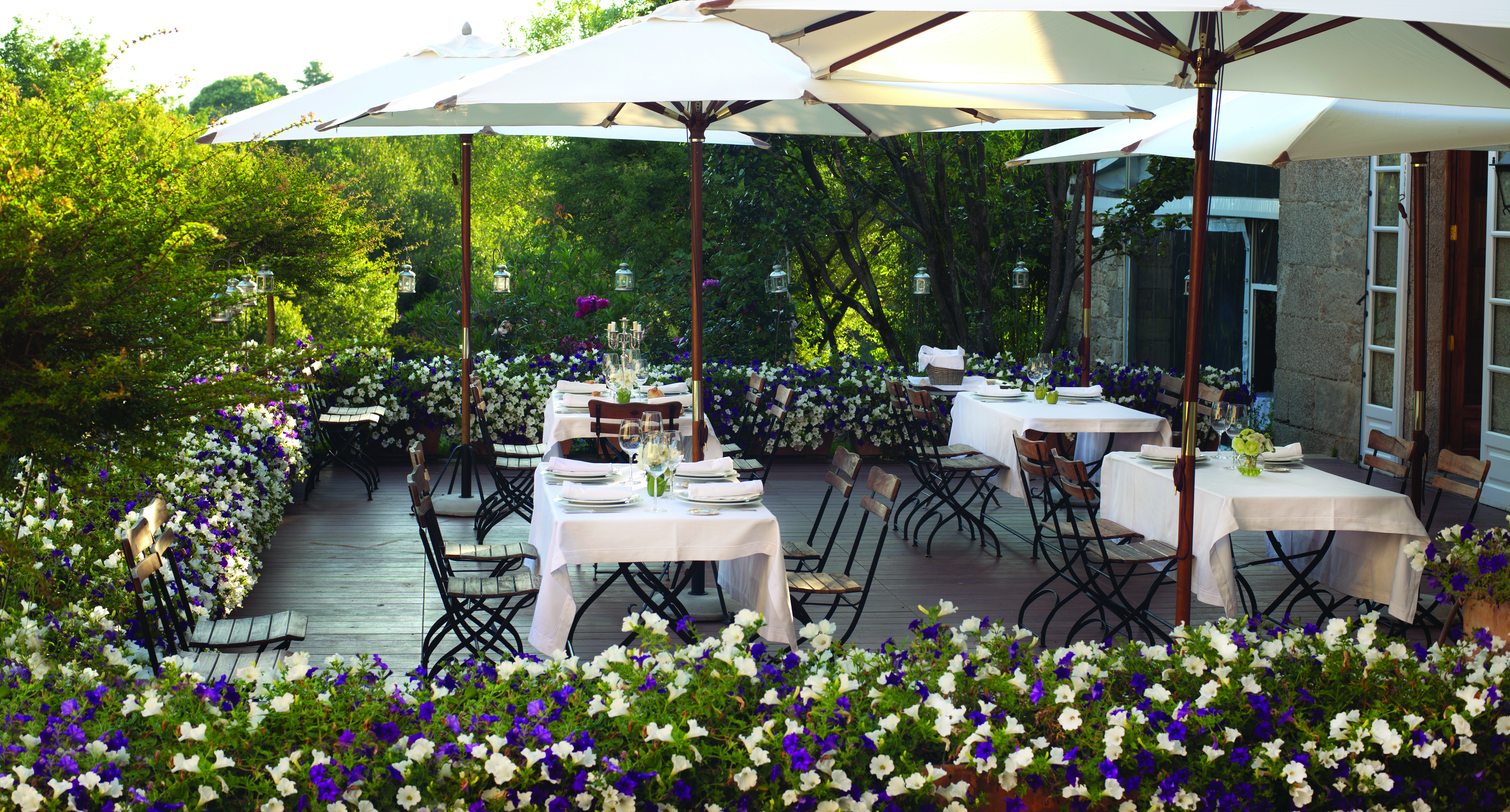 A Quinta Da Auga Galicia restaurant outdoor dining area umbrellas flowers