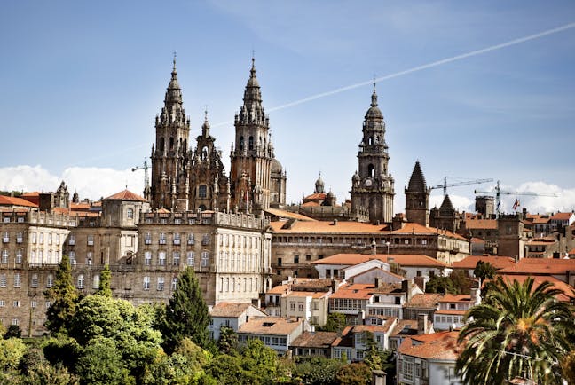 Towers of the cathedral above the red roofs of the town of Santiago de Compostela