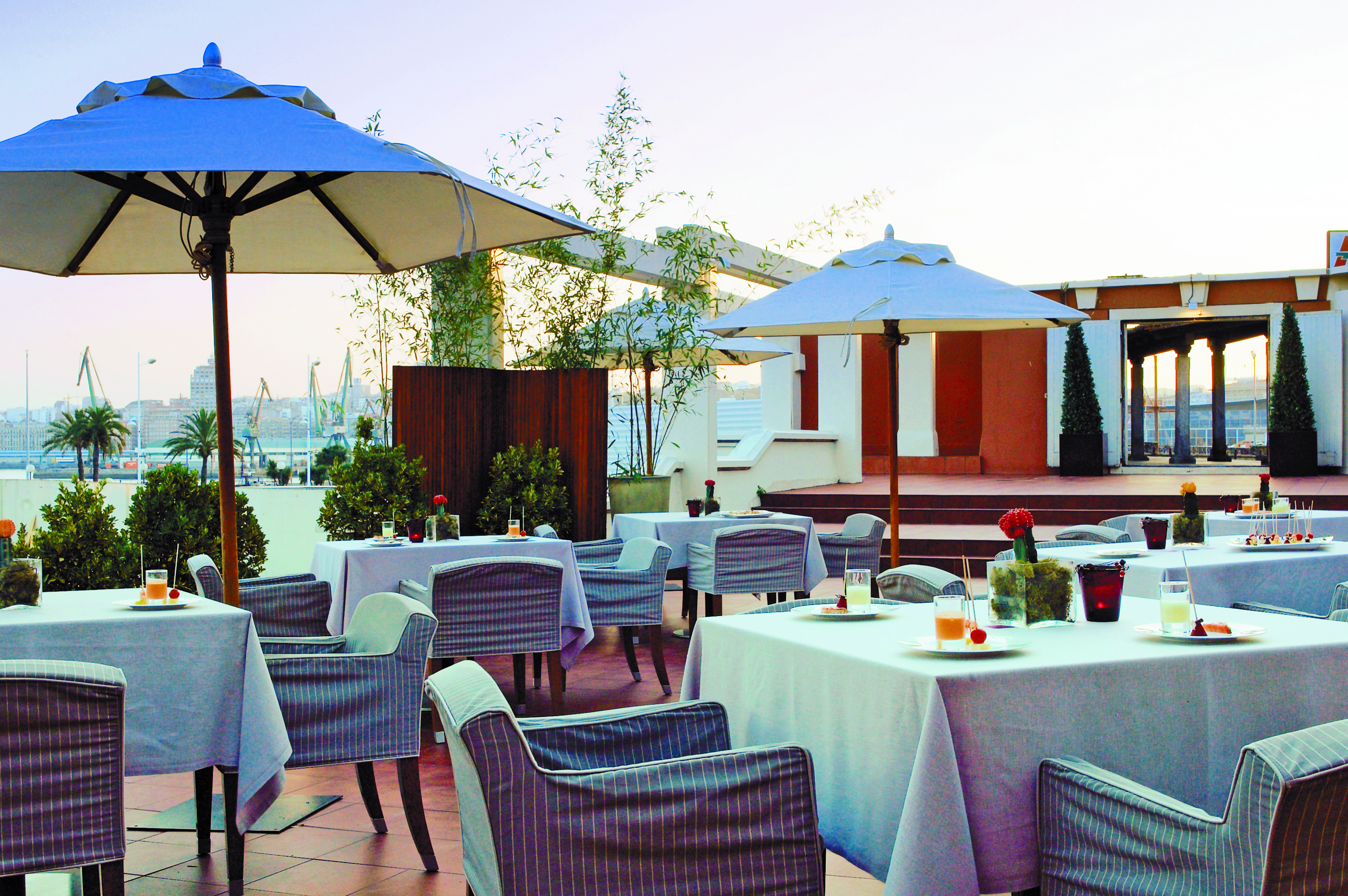 Hesperia Finisterre Green Spain terrace outdoor seating area tables umbrellas