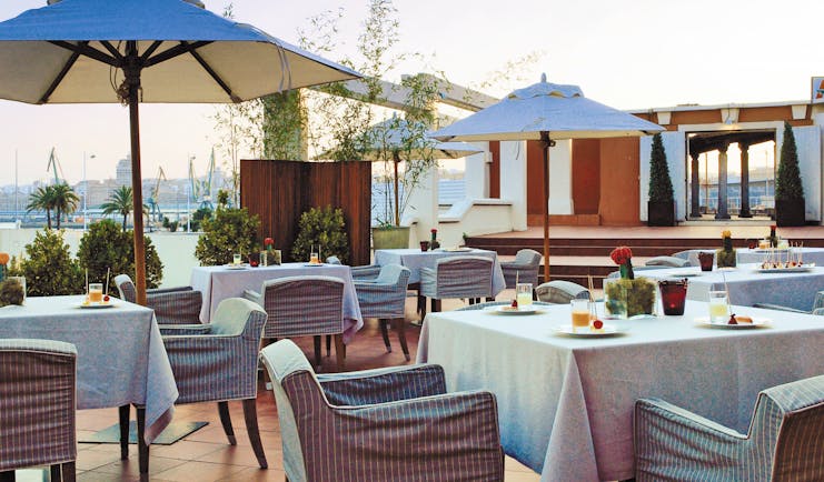 Hesperia Finisterre Green Spain terrace outdoor seating area tables umbrellas