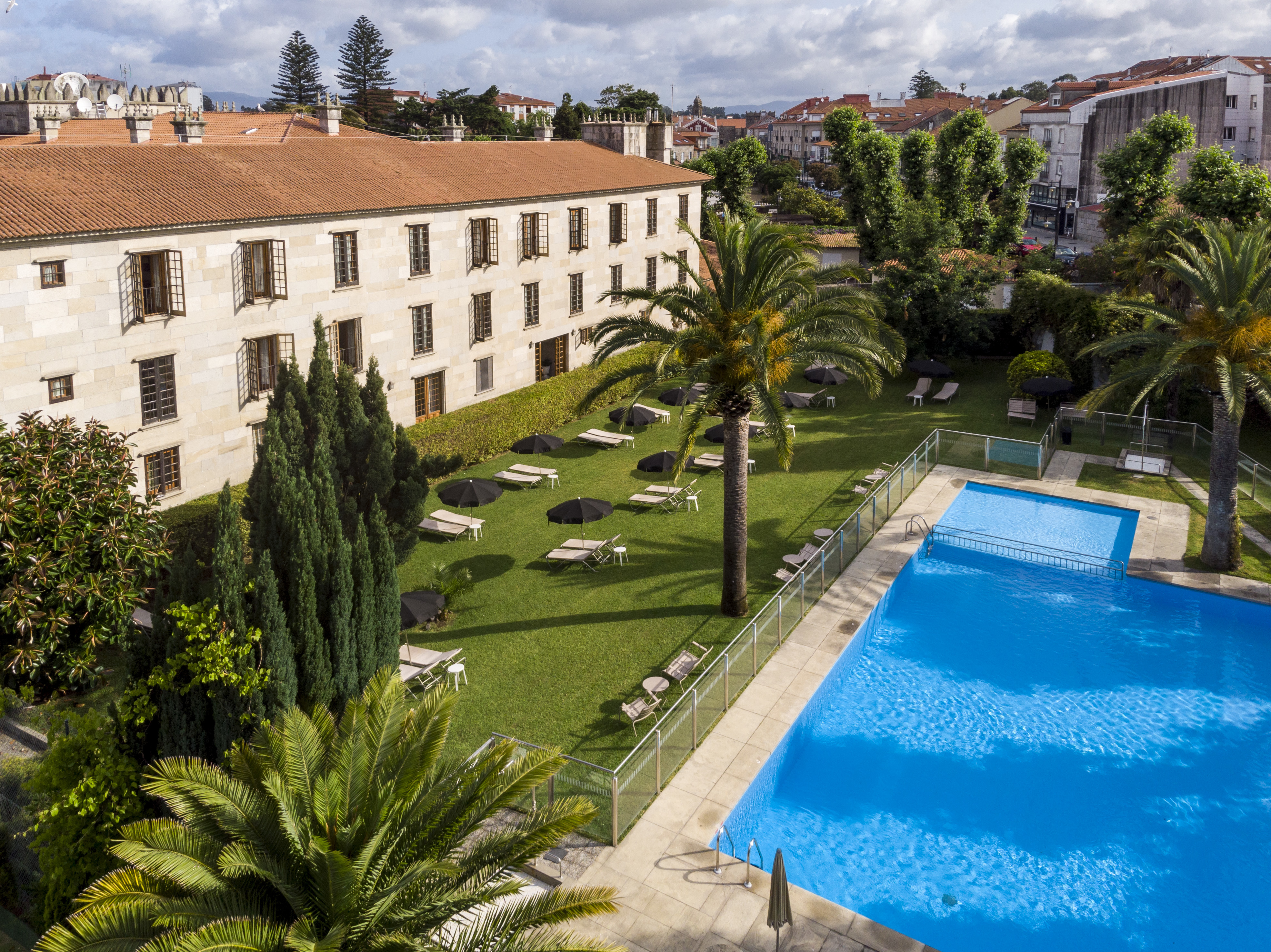 parador de cambados view of swimming pool and trees surrounding it