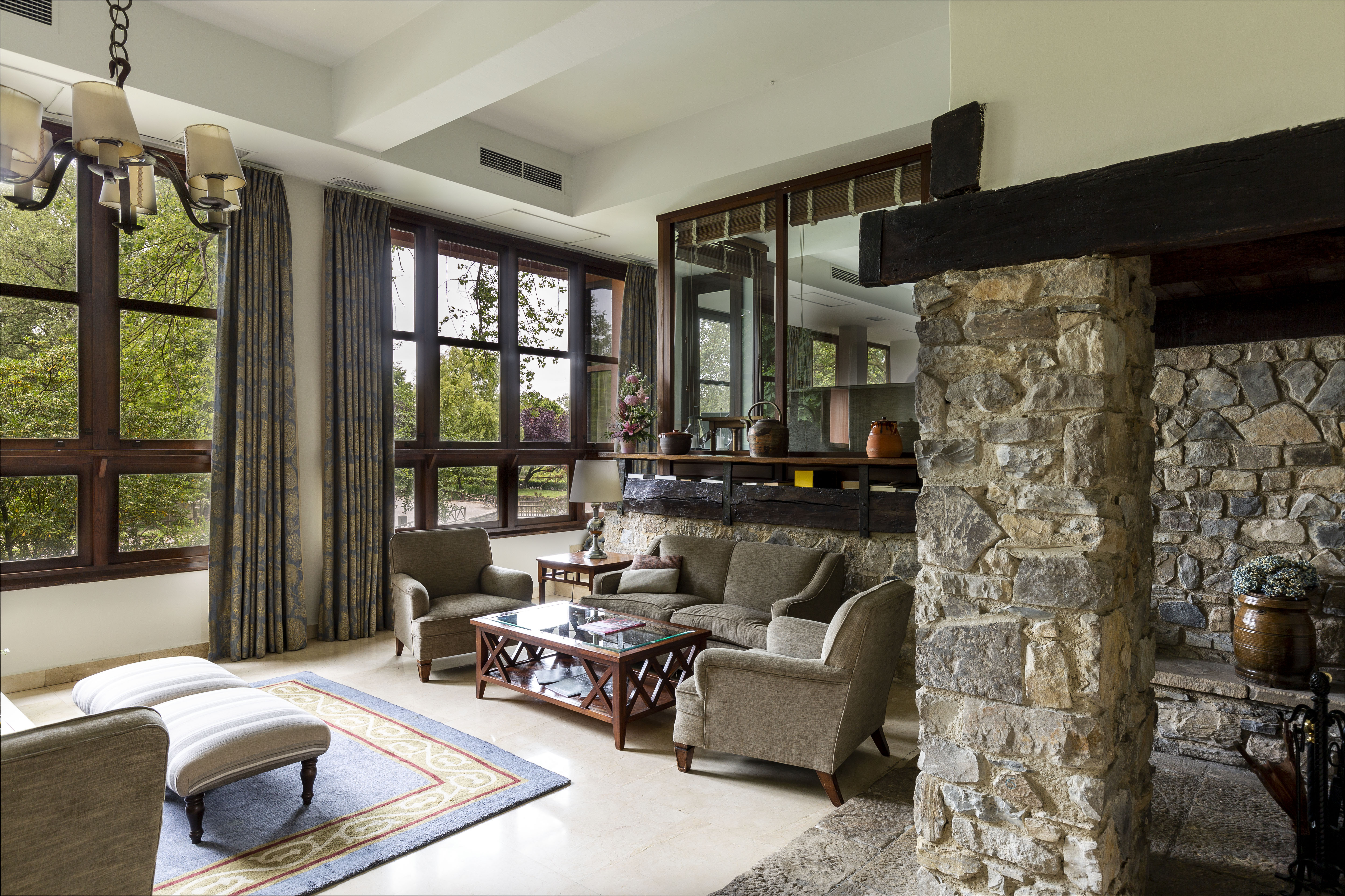 Parador de Gijon lounge, seating area, tables and chairs, exposed brick, traditional decor