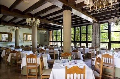 Parador de Gijon restaurant, dining tables, chairs, traditional decor