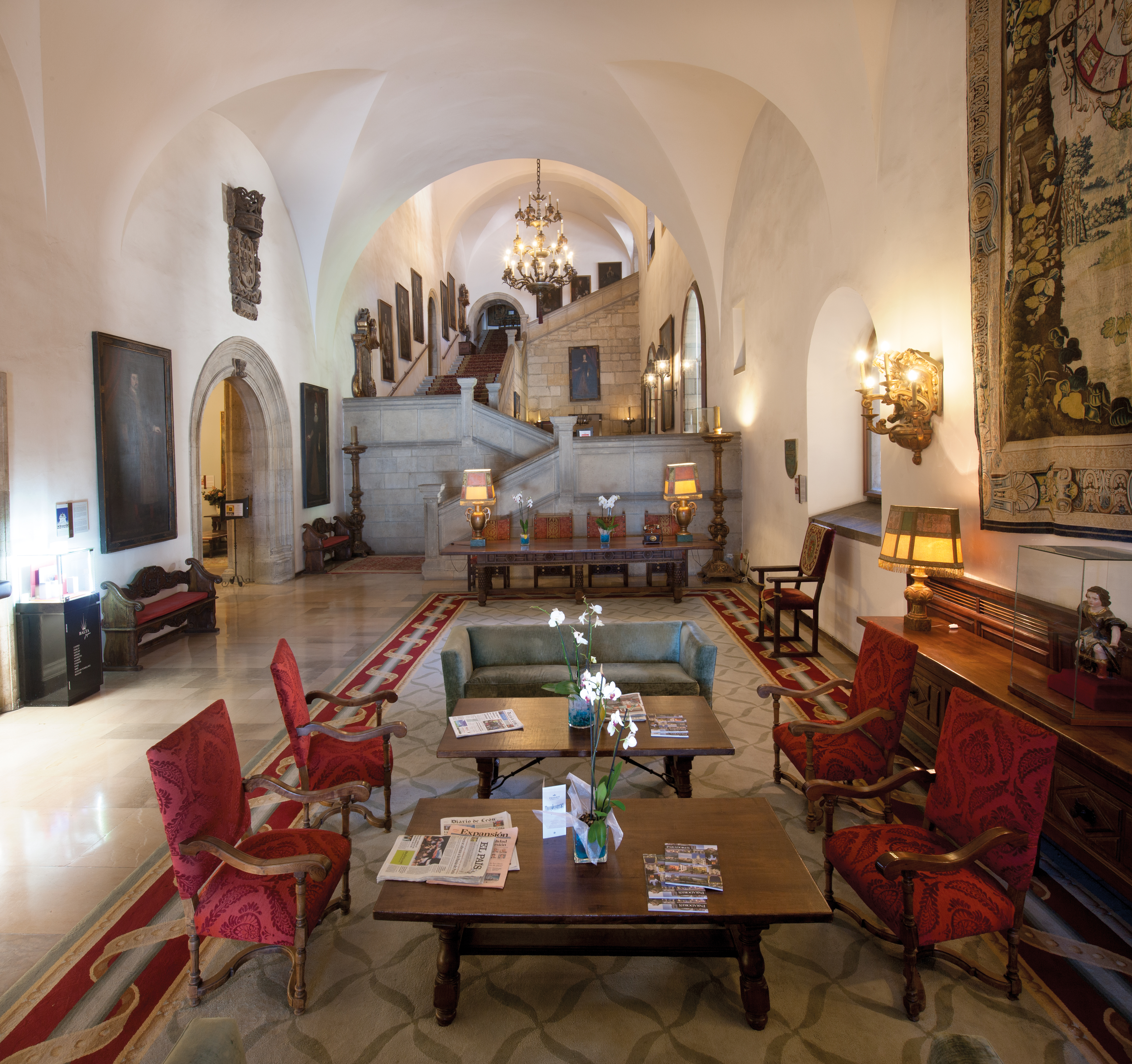 Reception with tables and chairs set out for seating, art work on the walls and candles