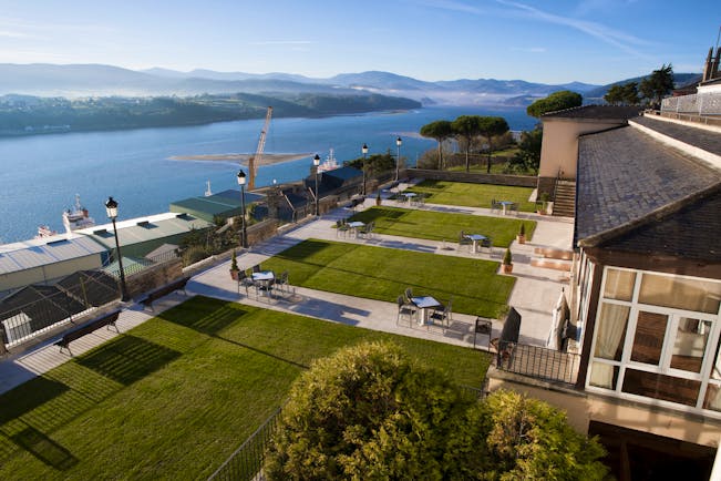 Parador de Ribadeo gardens, lawns, outdoor searinf, overlooking river and mountains