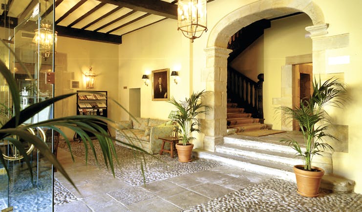Parador de Santillana Gil Blas Green Spain lobby sofa plants stone floor rustic décor