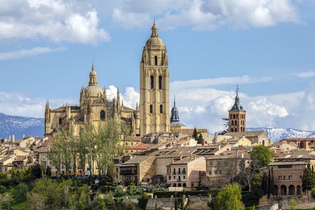 Tall spire and towers of the cathedral and city centre buildings from a distance at Segovia