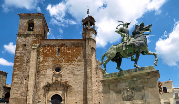 Statue of Francsico Pizarro on horseback outside the medieval stone church of St Martin in Trujillo