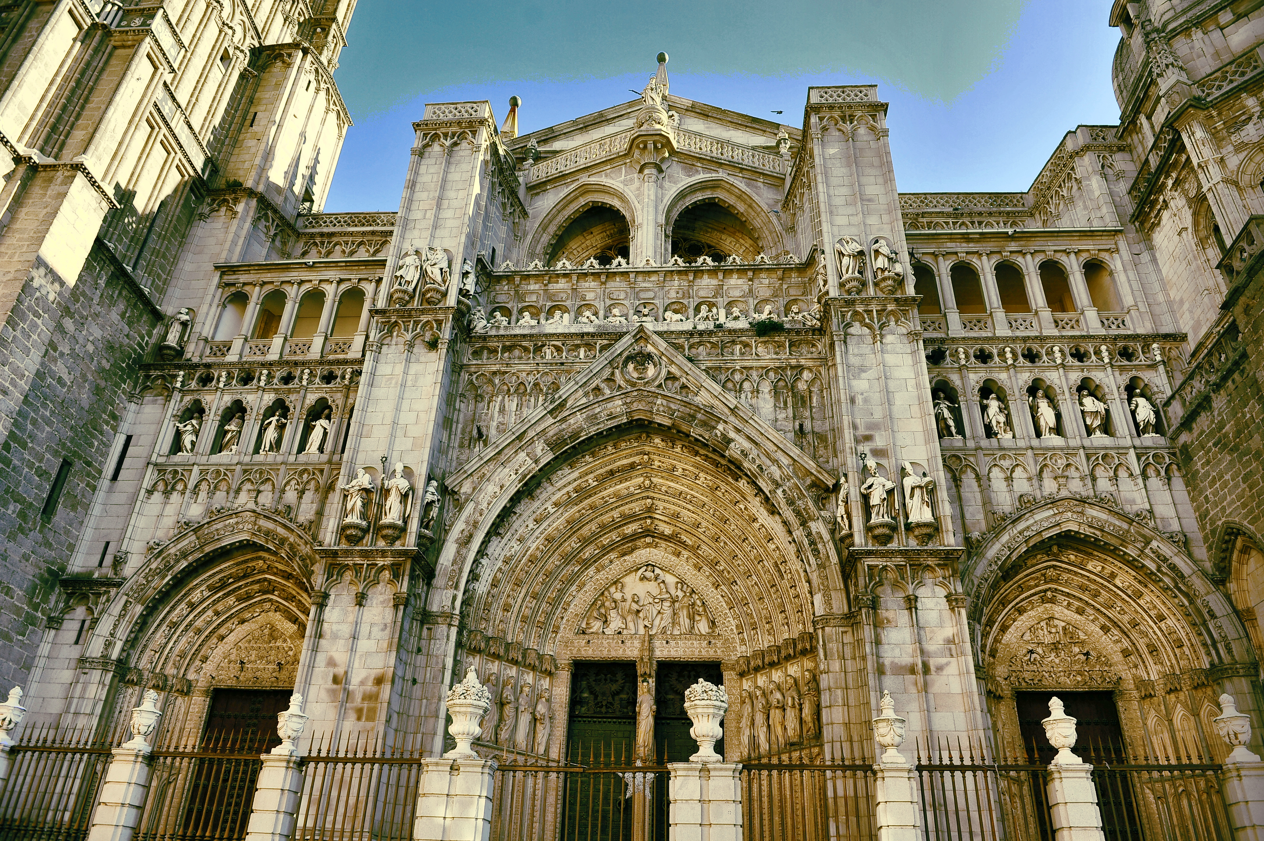 Entrance to Toledo cathedral with three doors of stone with intricate carvings