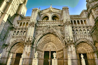 Entrance to Toledo cathedral with three doors of stone with intricate carvings
