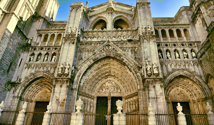 Entrance to Toledo cathedral with three doors of stone with intricate carvings