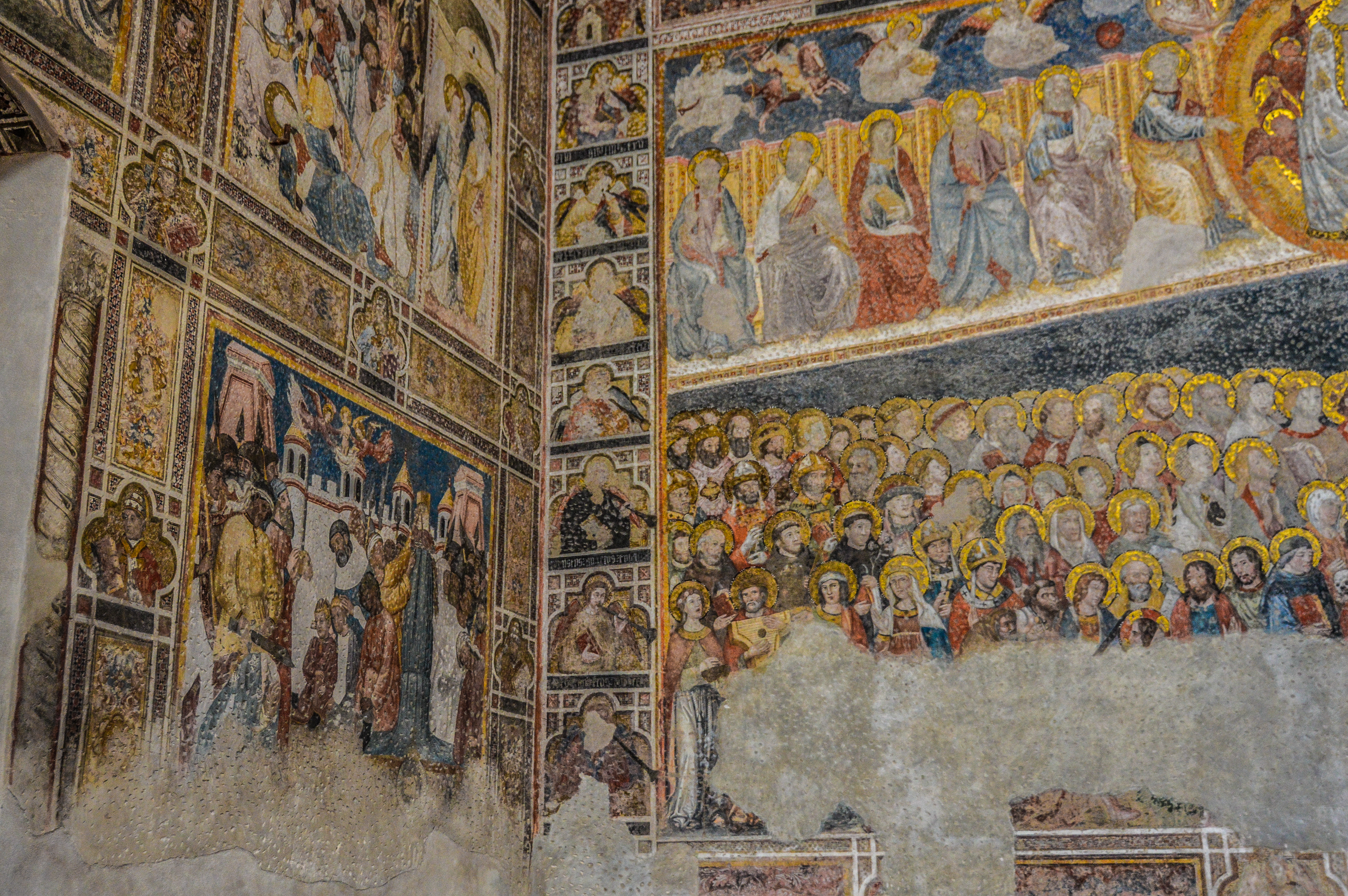 Mural of medieval saints with gold halos inside the cathedral of Toledo