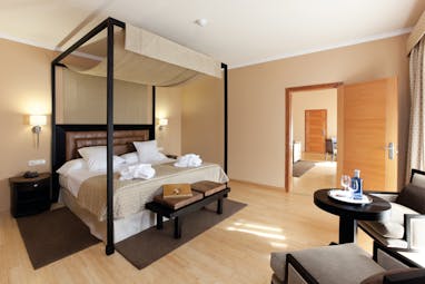 Hospes Palacio de Arenales Heart of Spain suite bedroom four poster bed modern décor