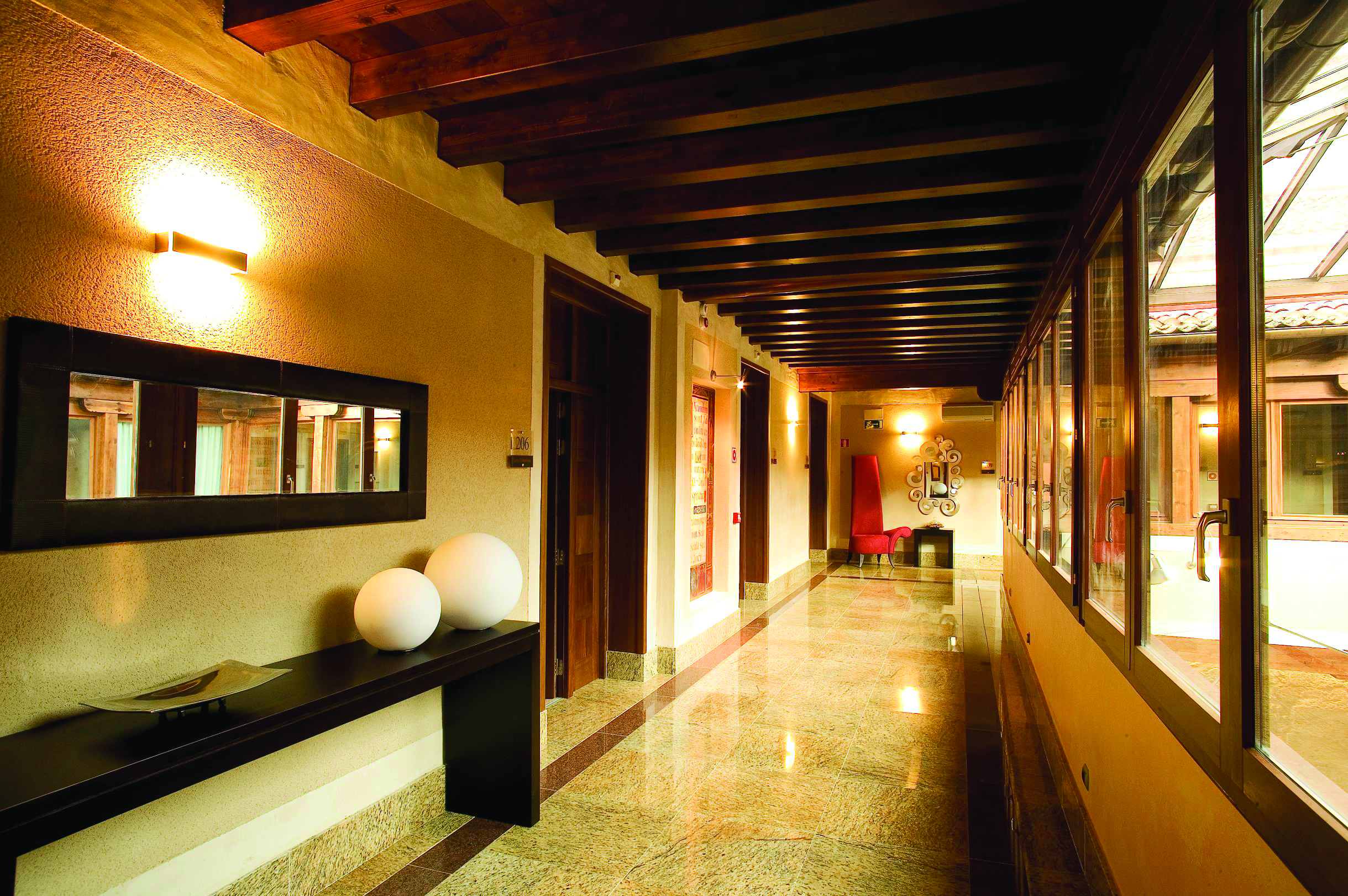 Palacio San Facundo Heart of Spain arcade hallway marble tiles ceiling beams modern décor
