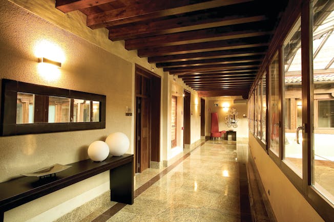 Palacio San Facundo Heart of Spain arcade hallway marble tiles ceiling beams modern décor