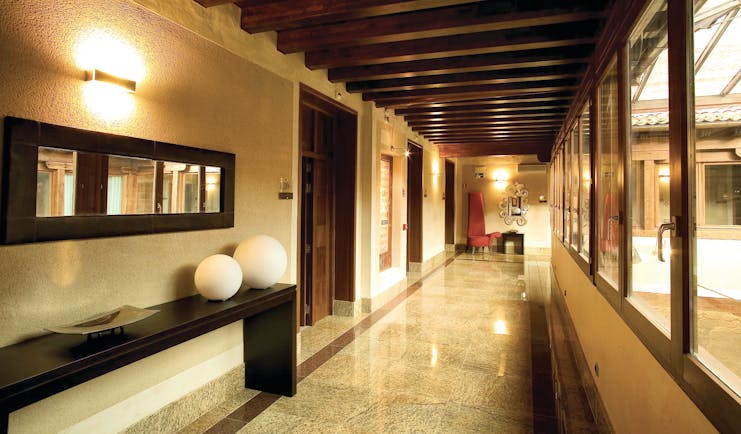 Palacio San Facundo Heart of Spain arcade hallway marble tiles ceiling beams modern décor