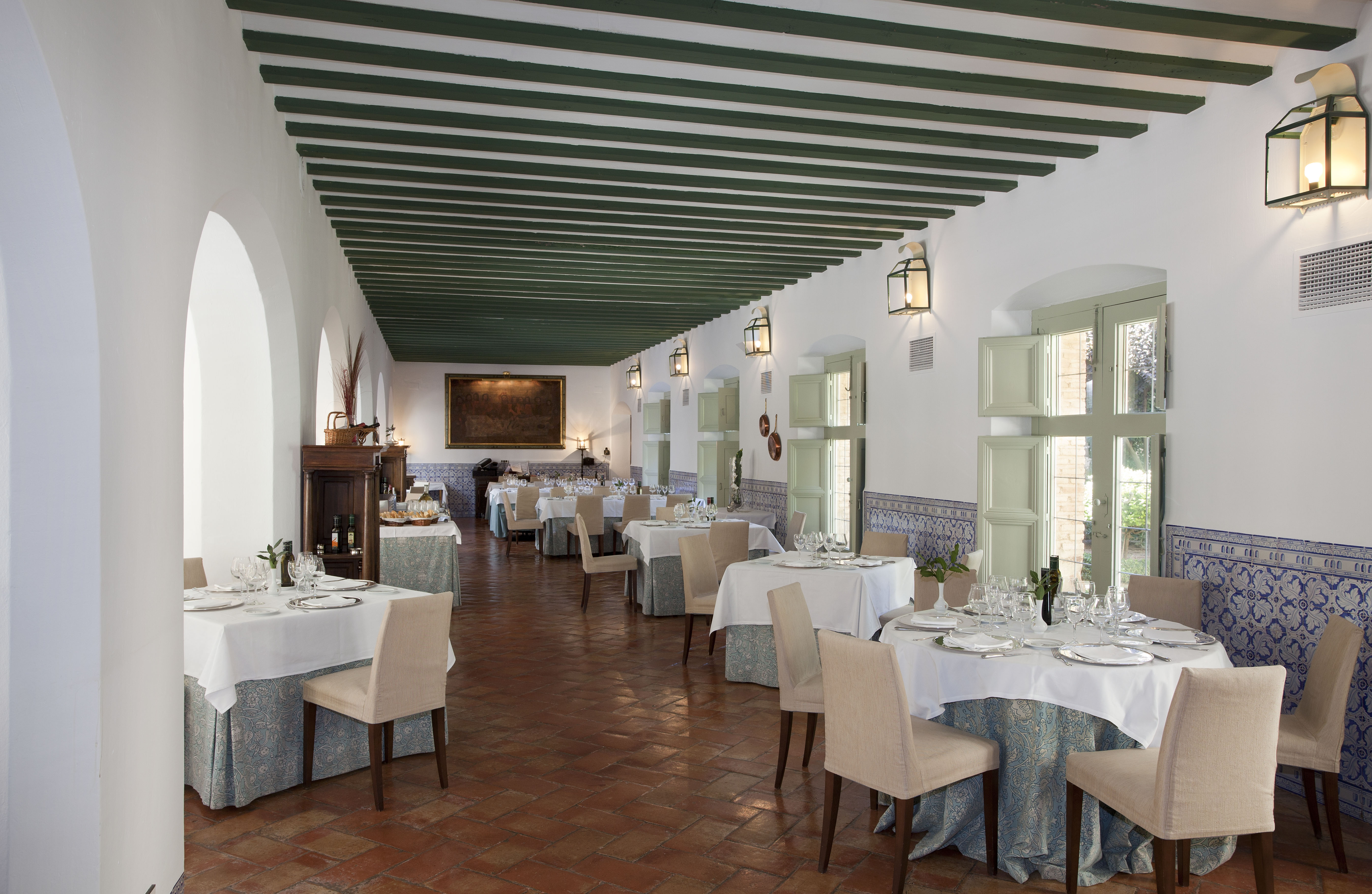 Parador de Almagro restaurant, dining tables, chairs, tiled floor, traditional architecture