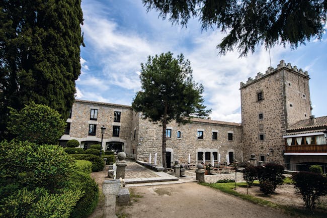 Parador de Avila Heart of Spain hotel exterior stone building pathway trees shrubbery