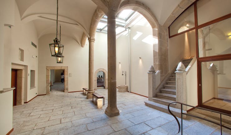 Interior of hotel with stone columns and archways 