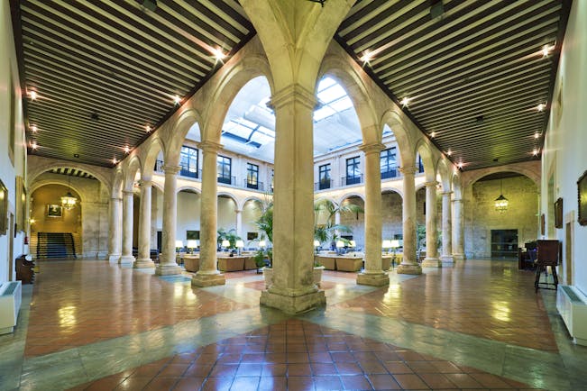Parador de Lerma lobby, marble columns, traditional decor and architecture, indoor seating area