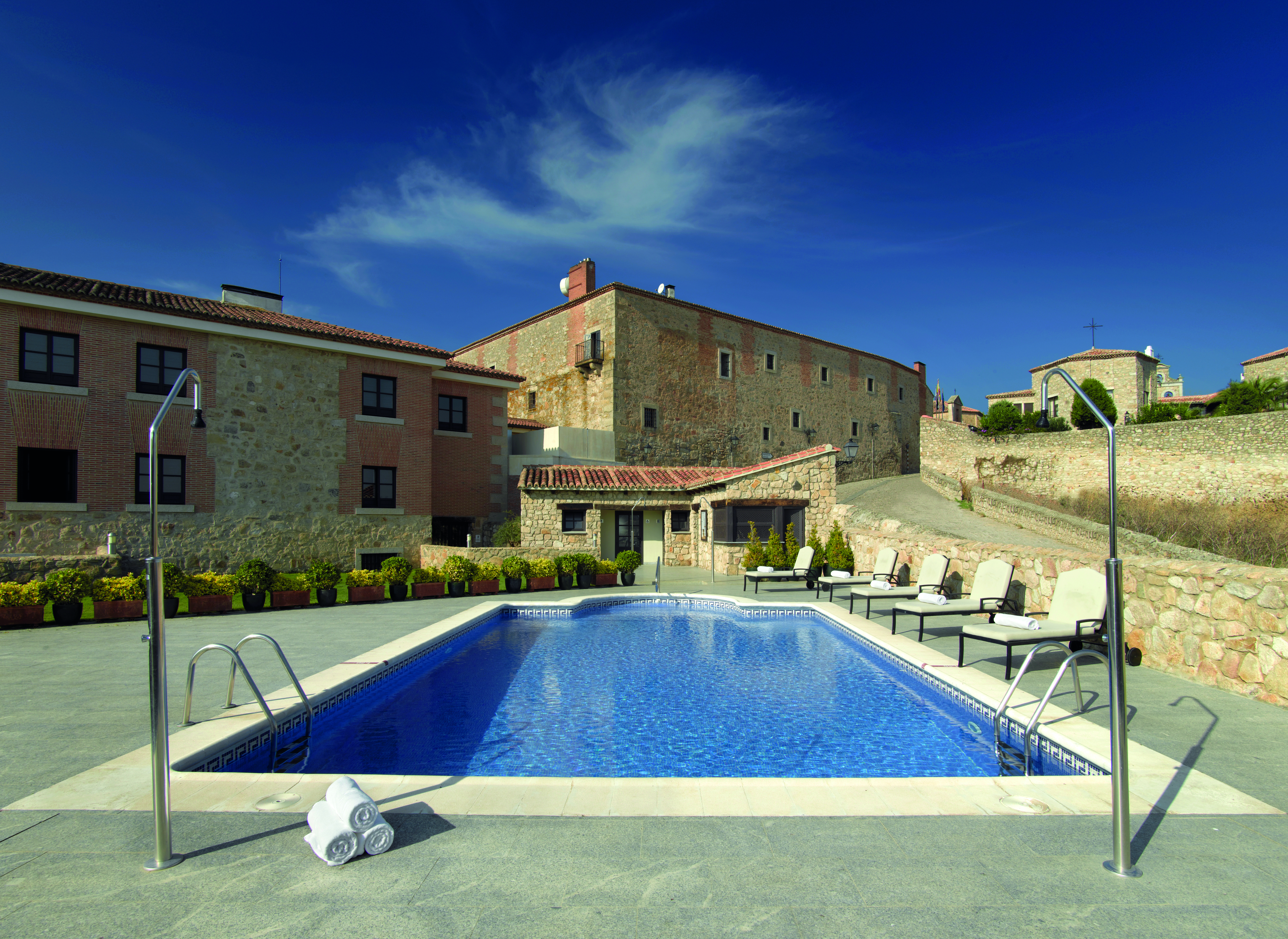 Parador de Trujillo Heart of Spain pool sun loungers hotel in background
