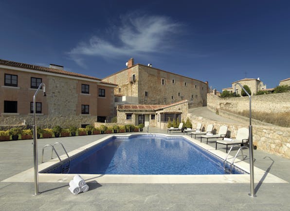 Parador de Trujillo Heart of Spain pool sun loungers hotel in background