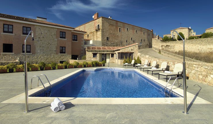 Parador de Trujillo Heart of Spain pool sun loungers hotel in background