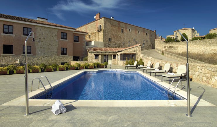 Parador de Trujillo Heart of Spain pool sun loungers hotel in background