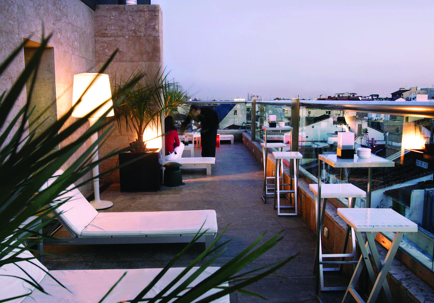 Hotel Urban Madrid terrace outdoor seating area sun loungers waiter views of the city