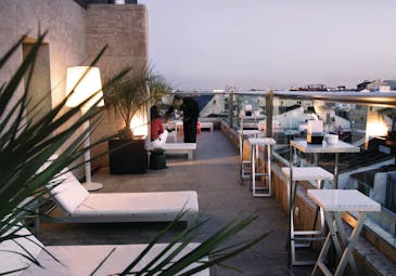 Hotel Urban Madrid terrace outdoor seating area sun loungers waiter views of the city