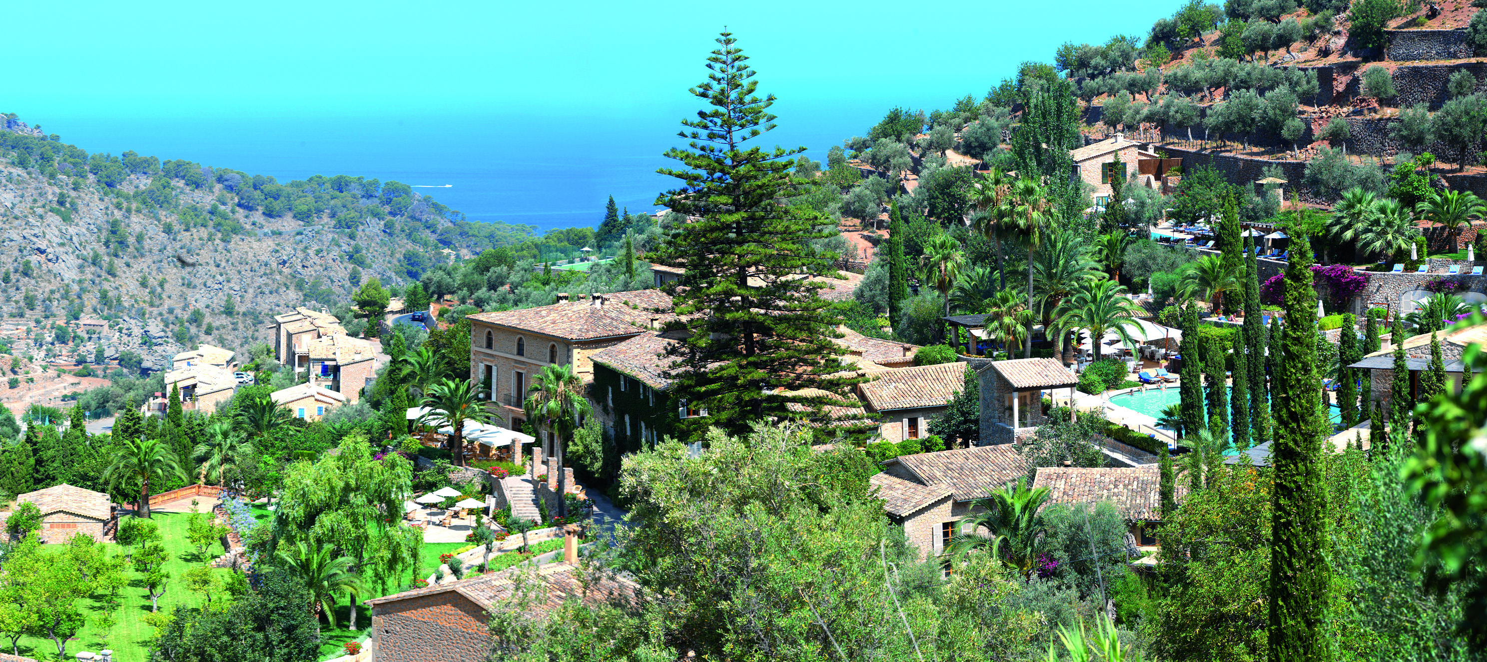 Belmond la Residencia Mallorca exterior buildings on mountainside with sea view