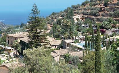 Belmond la Residencia Mallorca exterior buildings on mountainside with sea view