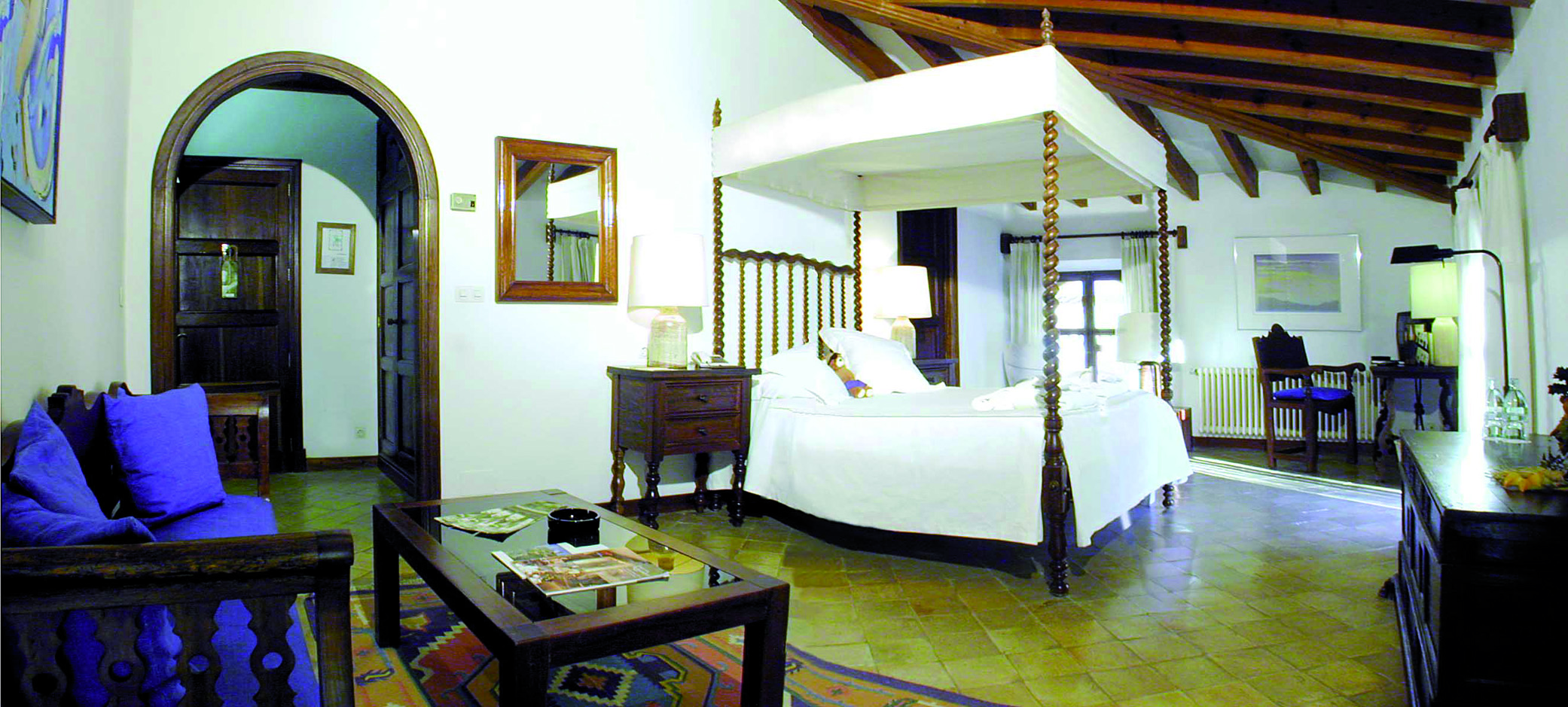 Belmond la Residencia Mallorca four poster bedroom with wooden bench