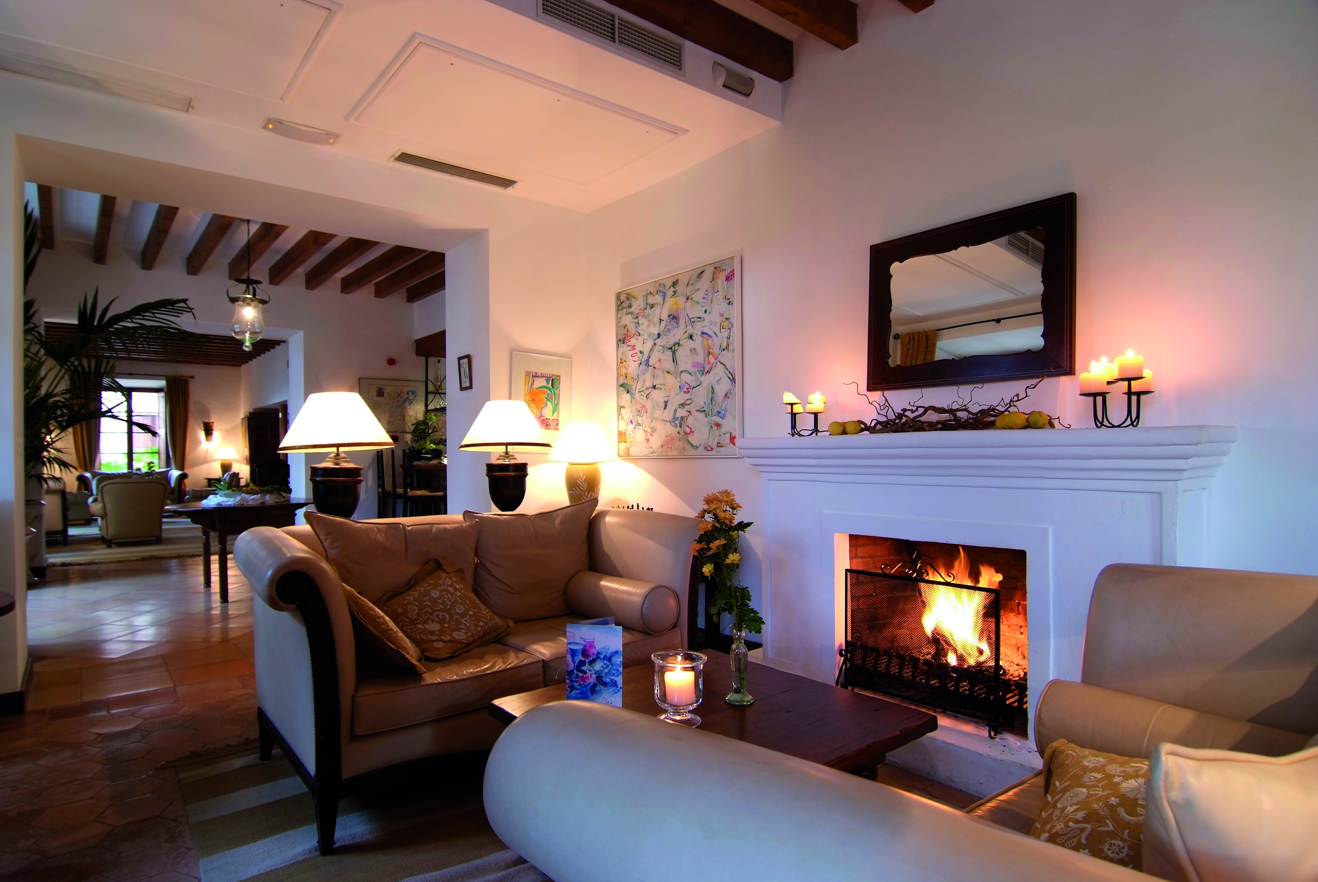 Belmond la Residencia Mallorca lounge area with sofas and fireplace