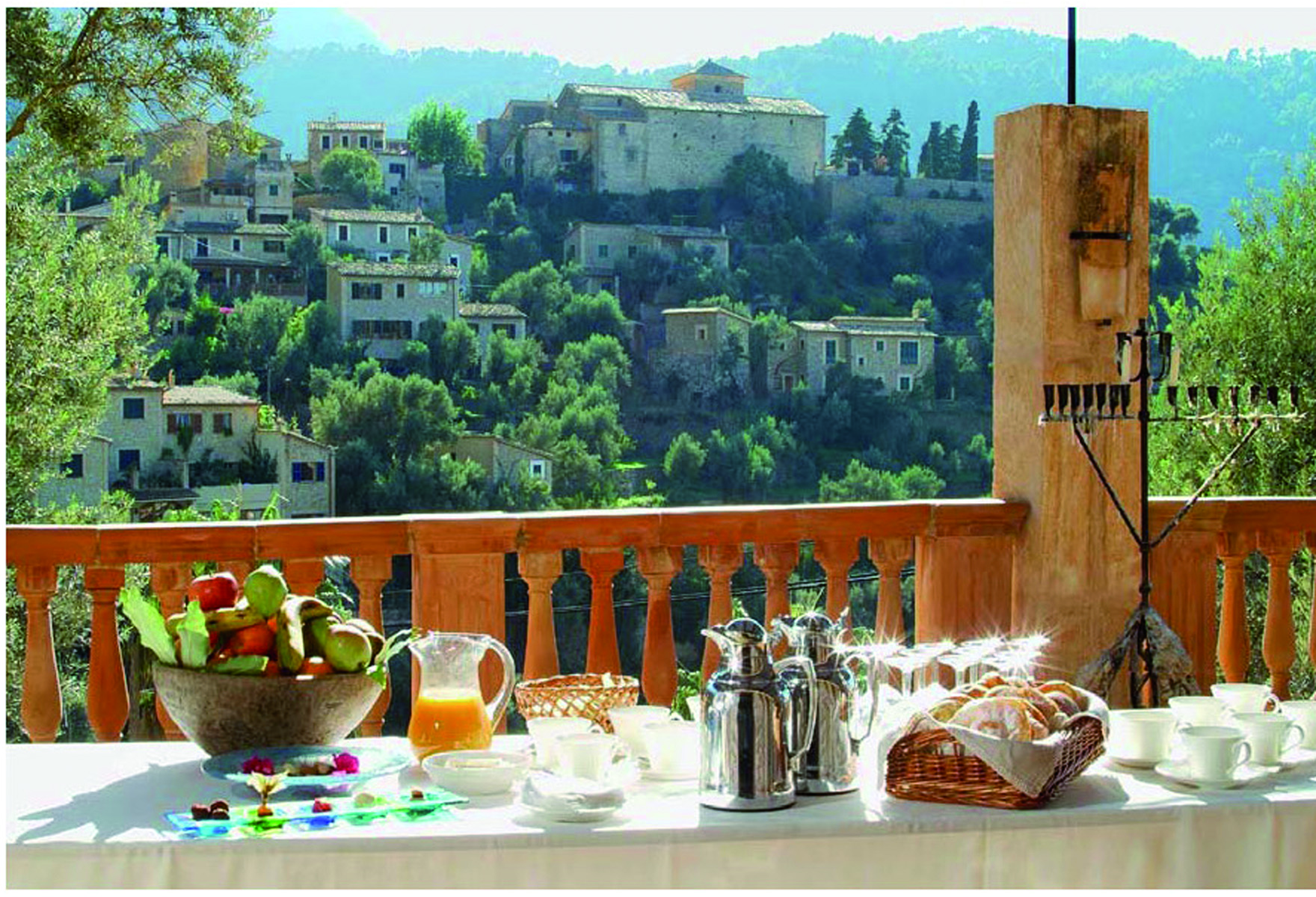 Belmond la Residencia Mallorca terrace dining area on balcony with view of village