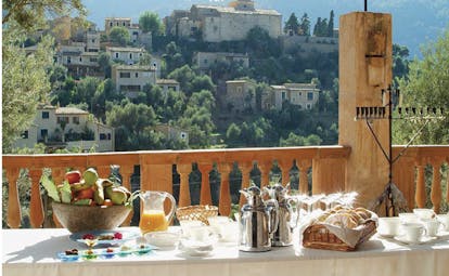 Belmond la Residencia Mallorca terrace dining area on balcony with view of village