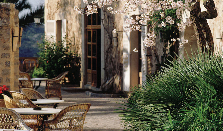 Belmond la Residencia Mallorca terrace outdoor seating area with trees and flowers